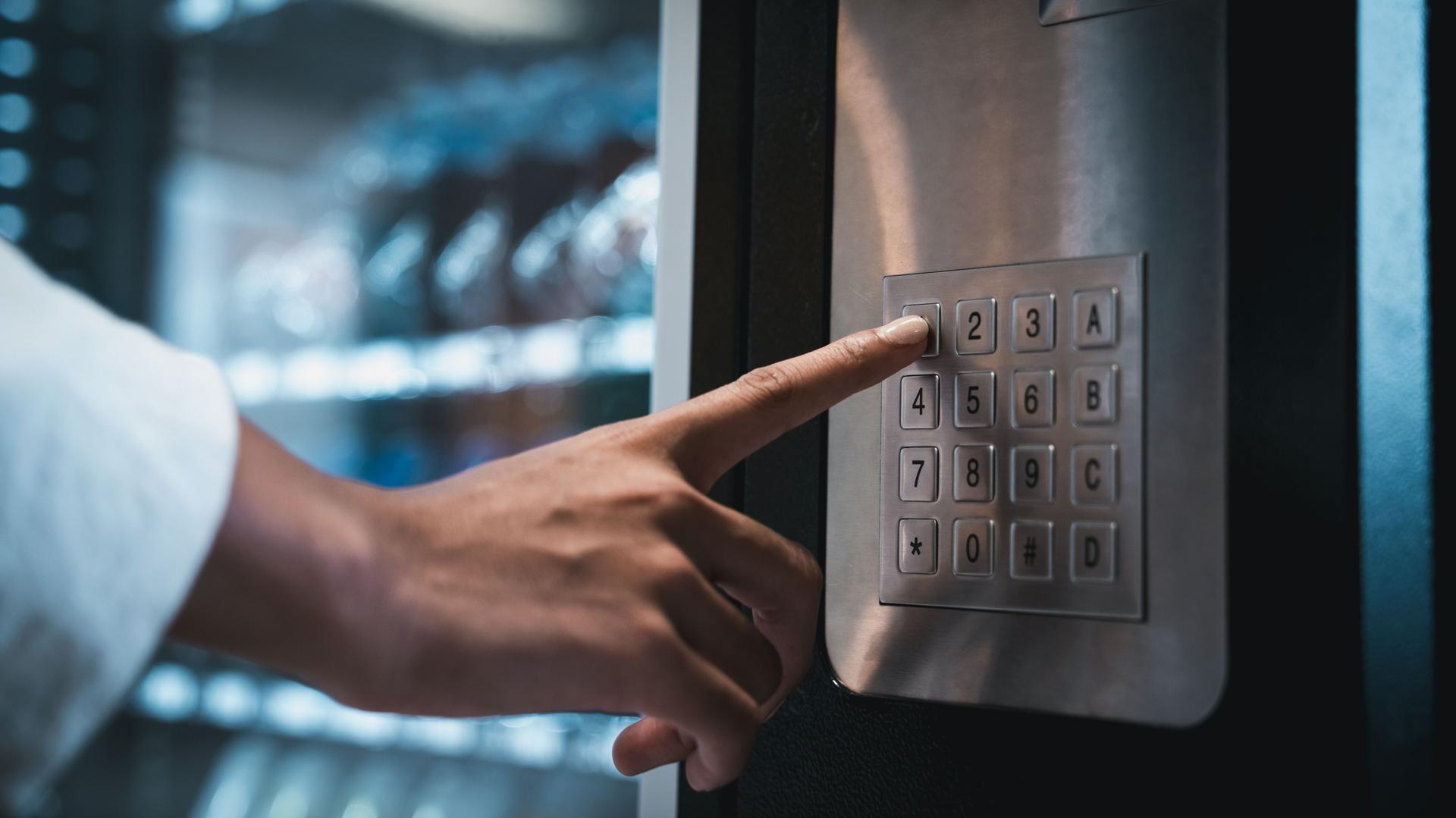 Close up hand of woman pushing button on vending machine for choosing a snack or drink. Small business and consumption concept.